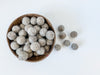 Fat and chunky gray wool balls for sensory play tray ideas and for use as math counters.