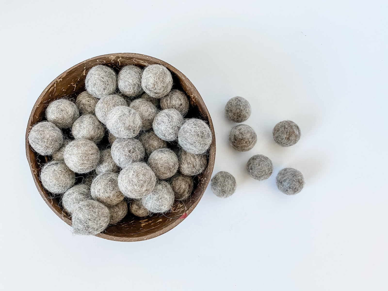 Fat and chunky gray wool balls for sensory play tray ideas and for use as math counters.