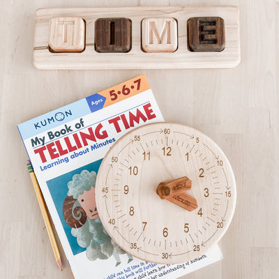 Homeschoolroom with a wooden dual sided clock for early learners.