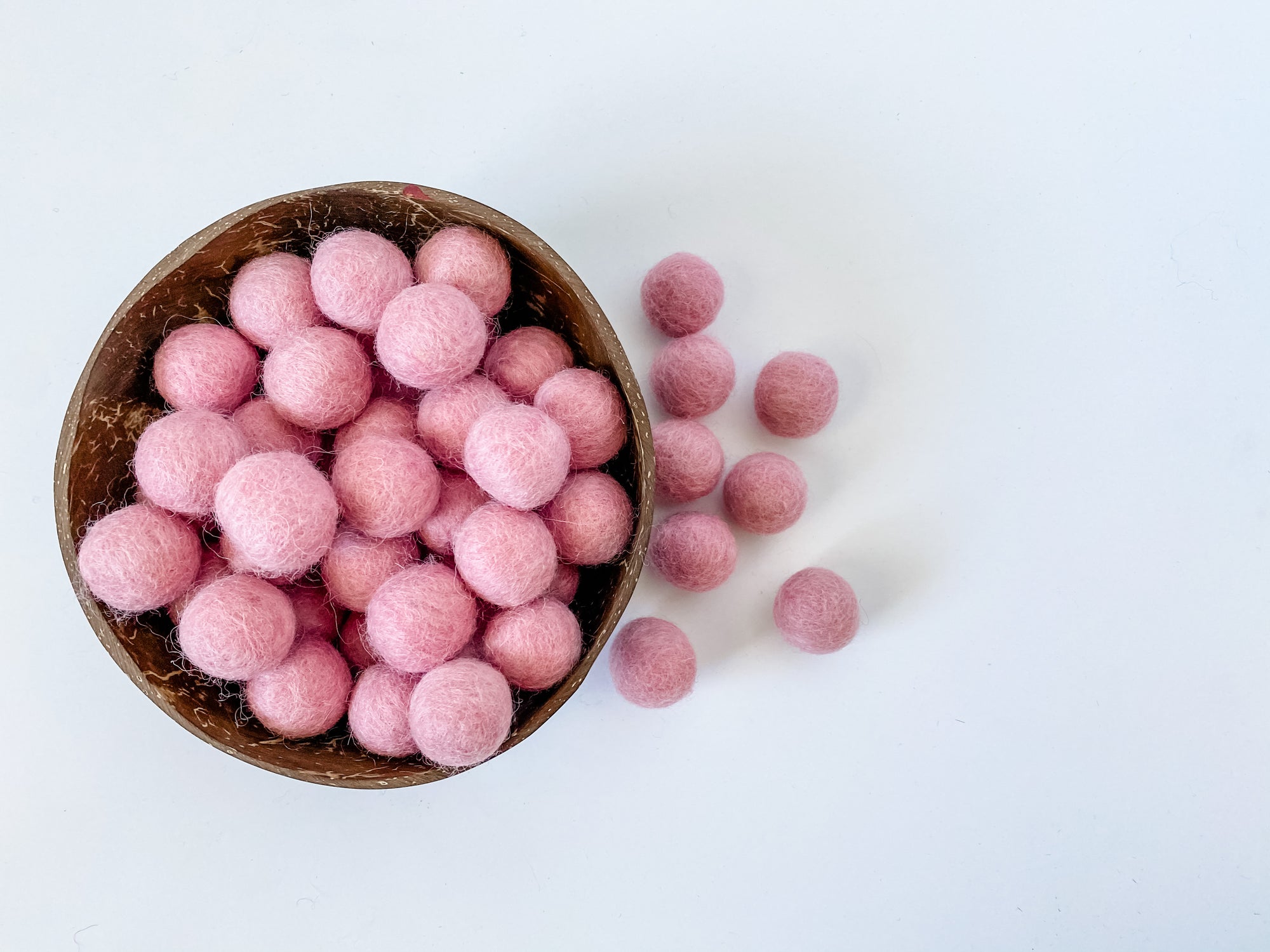 Fat and chunky big pink wool balls for sensory play.
