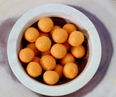 Orange chunky felt balls for sensory play.