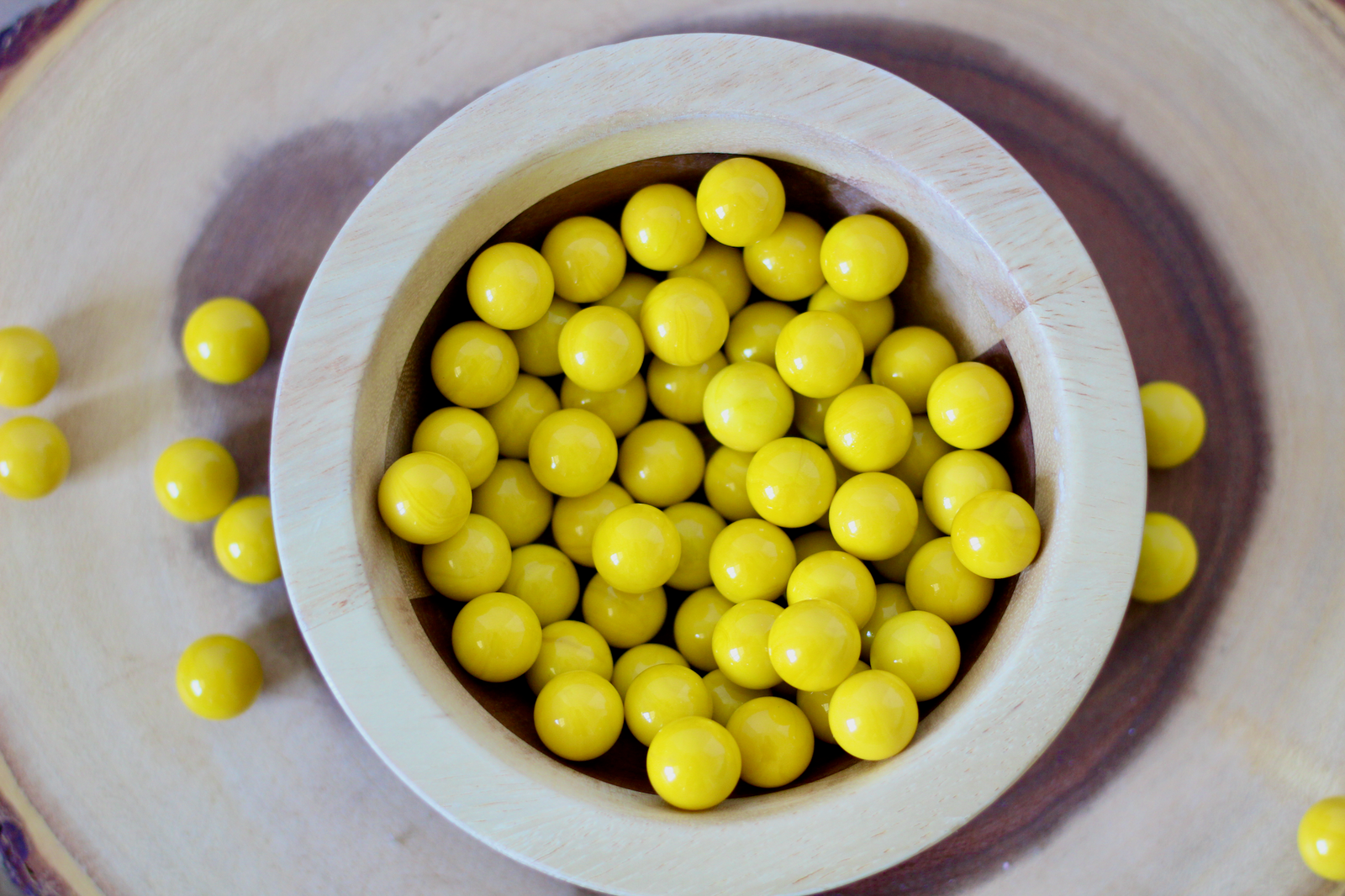 Yellow marble manipulatives for montessori homeschooling and sensory play.