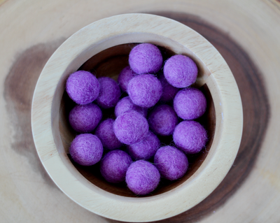 Purple chunky felt balls for sensory play.