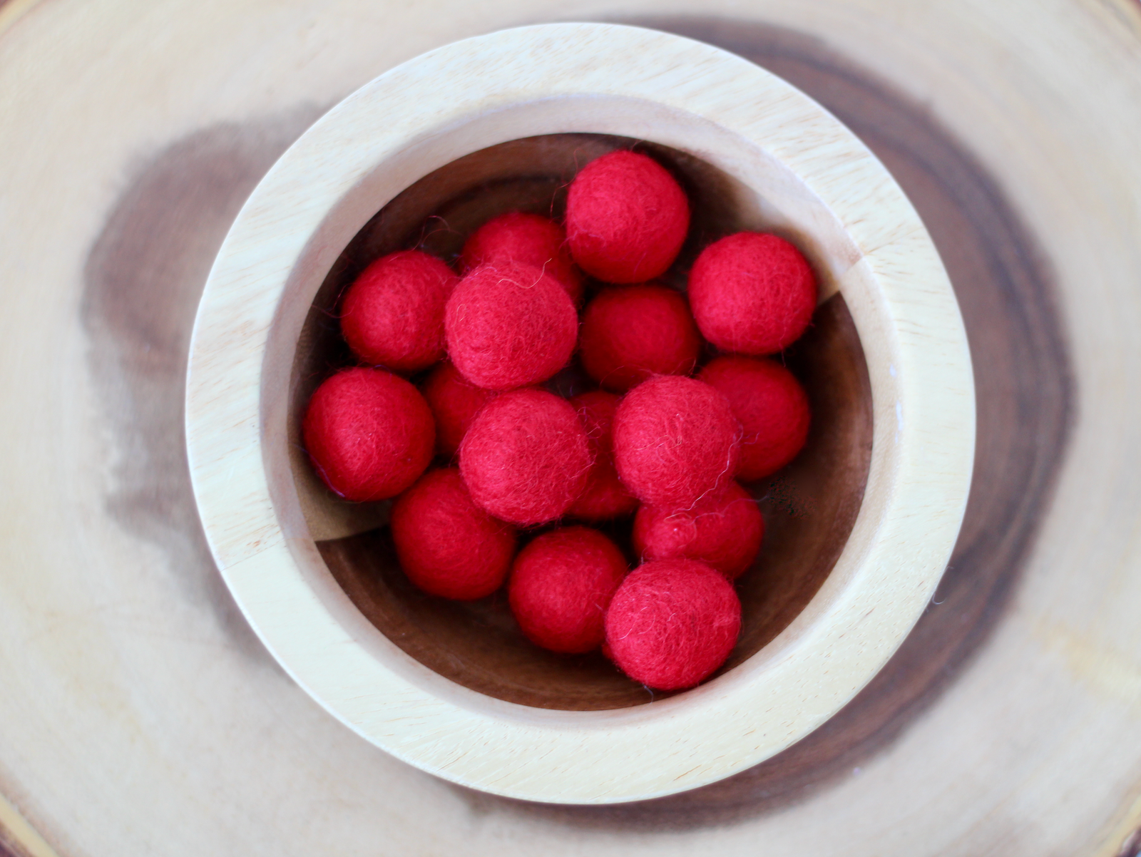 Chunky red felt balls for messy play and to use as math counters.