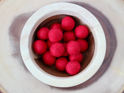 Chunky red felt balls for messy play and to use as math counters.